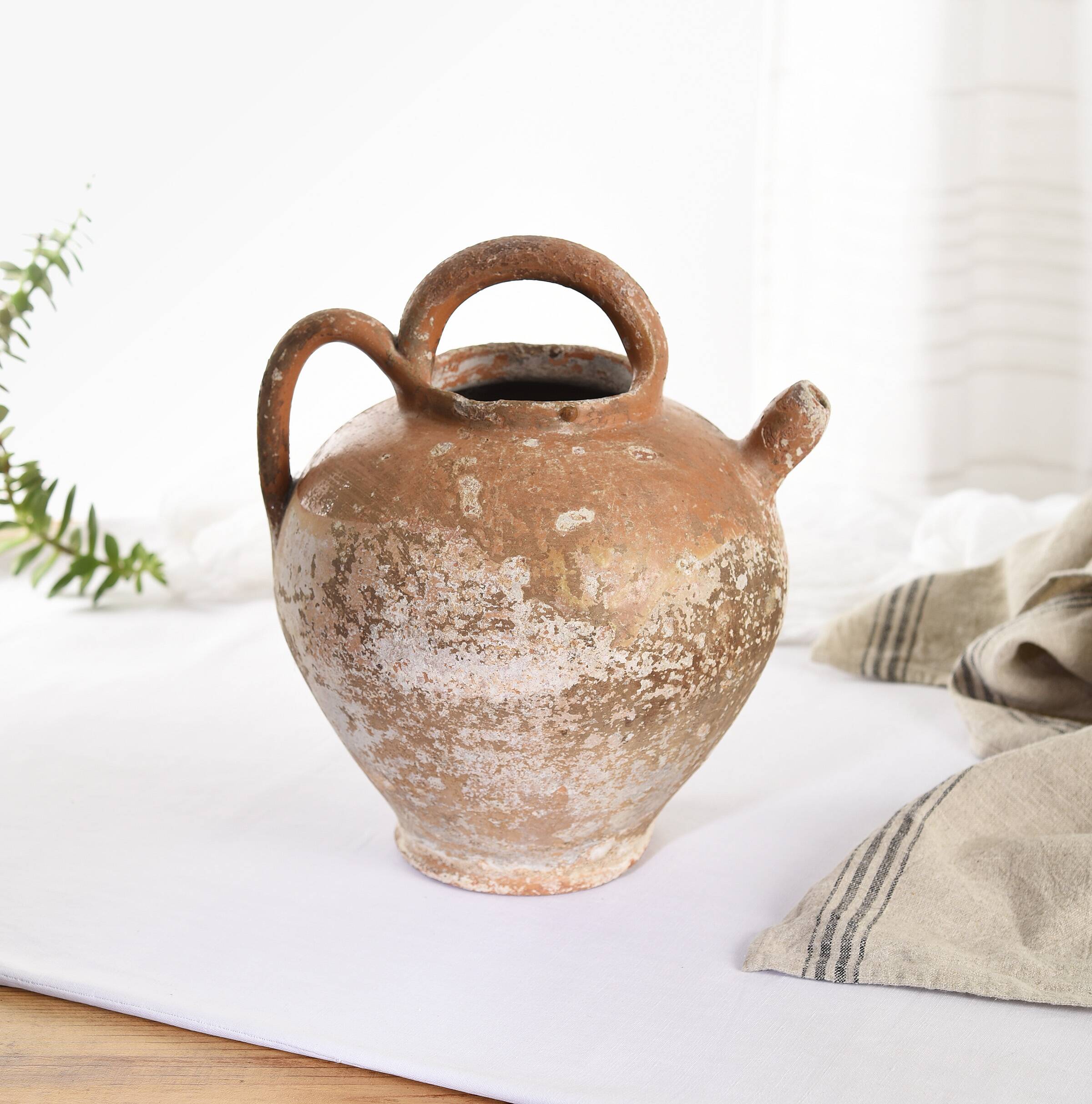 Old water jug. Gargoulette. Old terracotta pitcher.