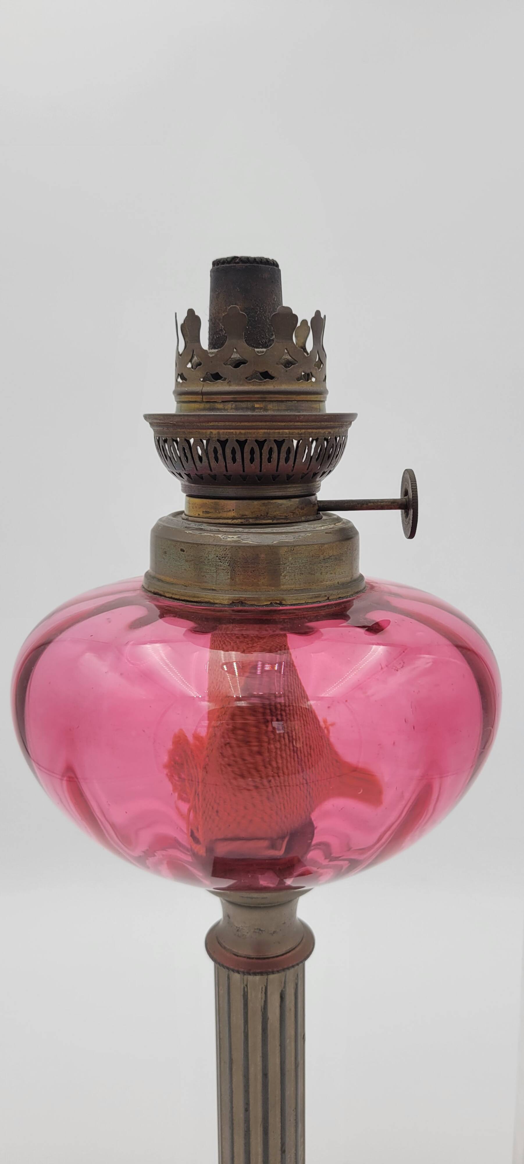 Old metal and pink glass oil lamp