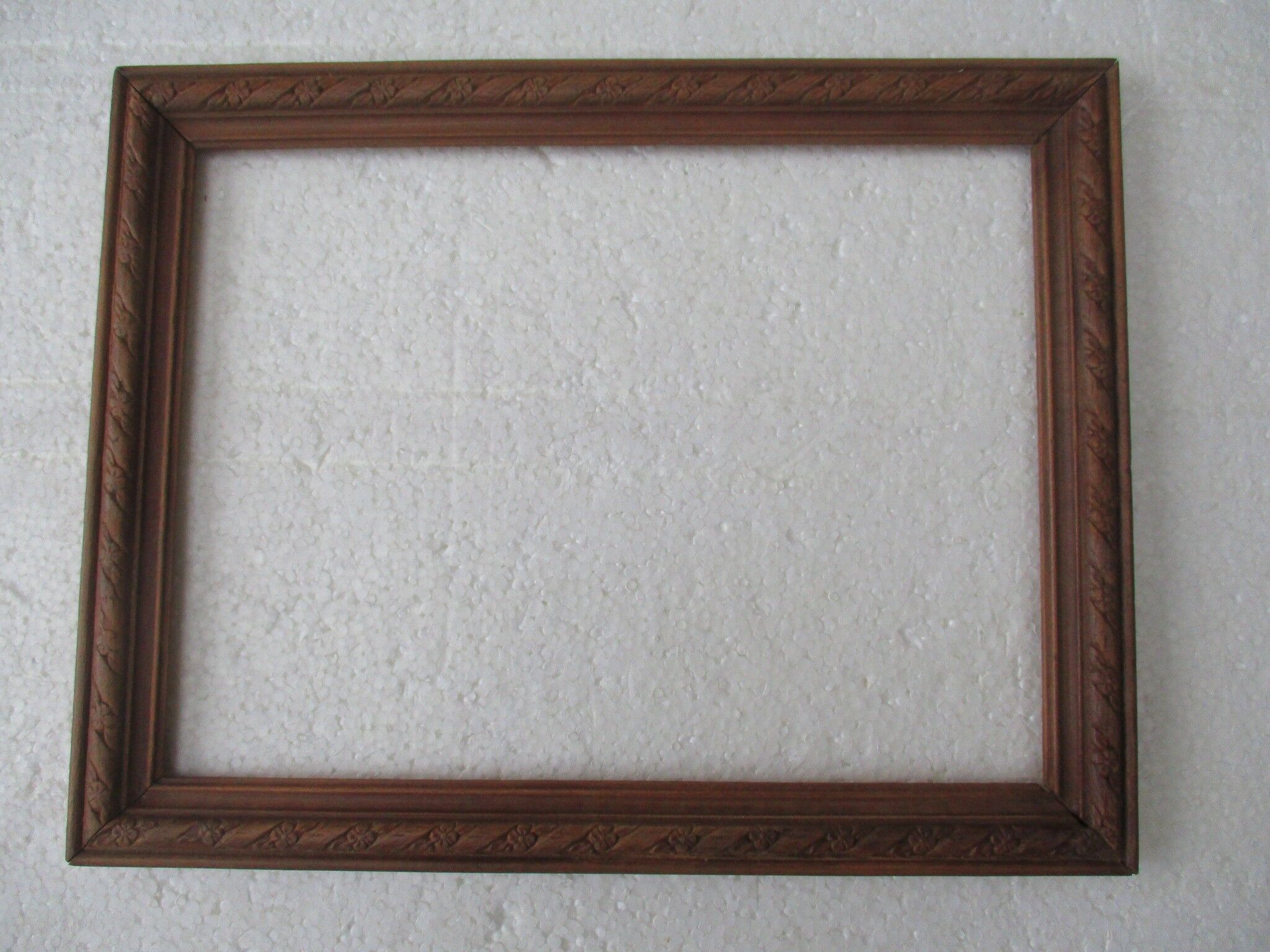 Wooden frame decorated with ribbon and flowers