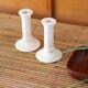 Pair of cream ceramic candlesticks