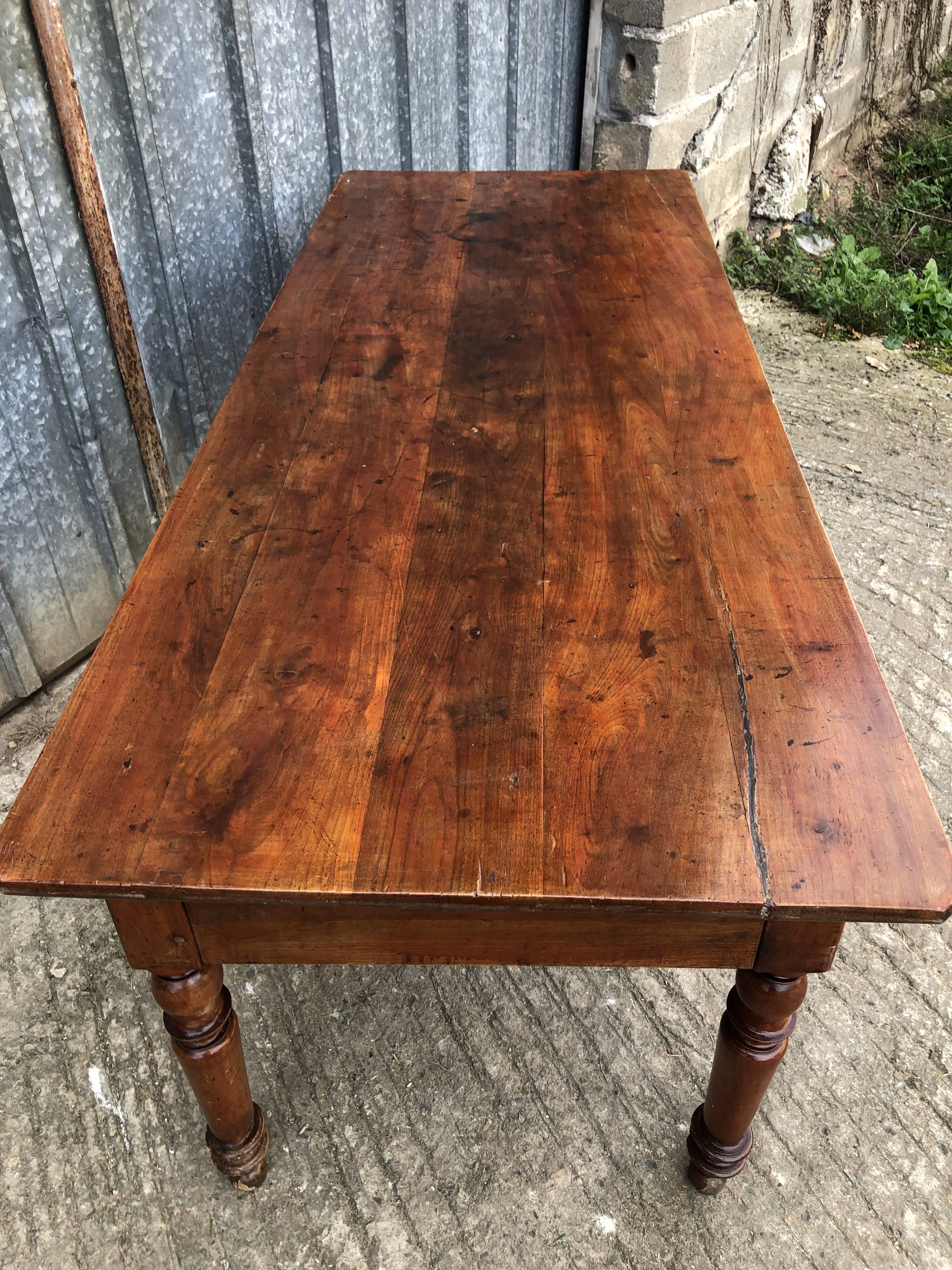 Old farmhouse table in solid cherry wood with 2 front drawers.
