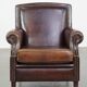 Dark brown sheepskin armchair finished with decorative nails