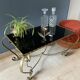 Table basse en métal doré et verre noir 1960