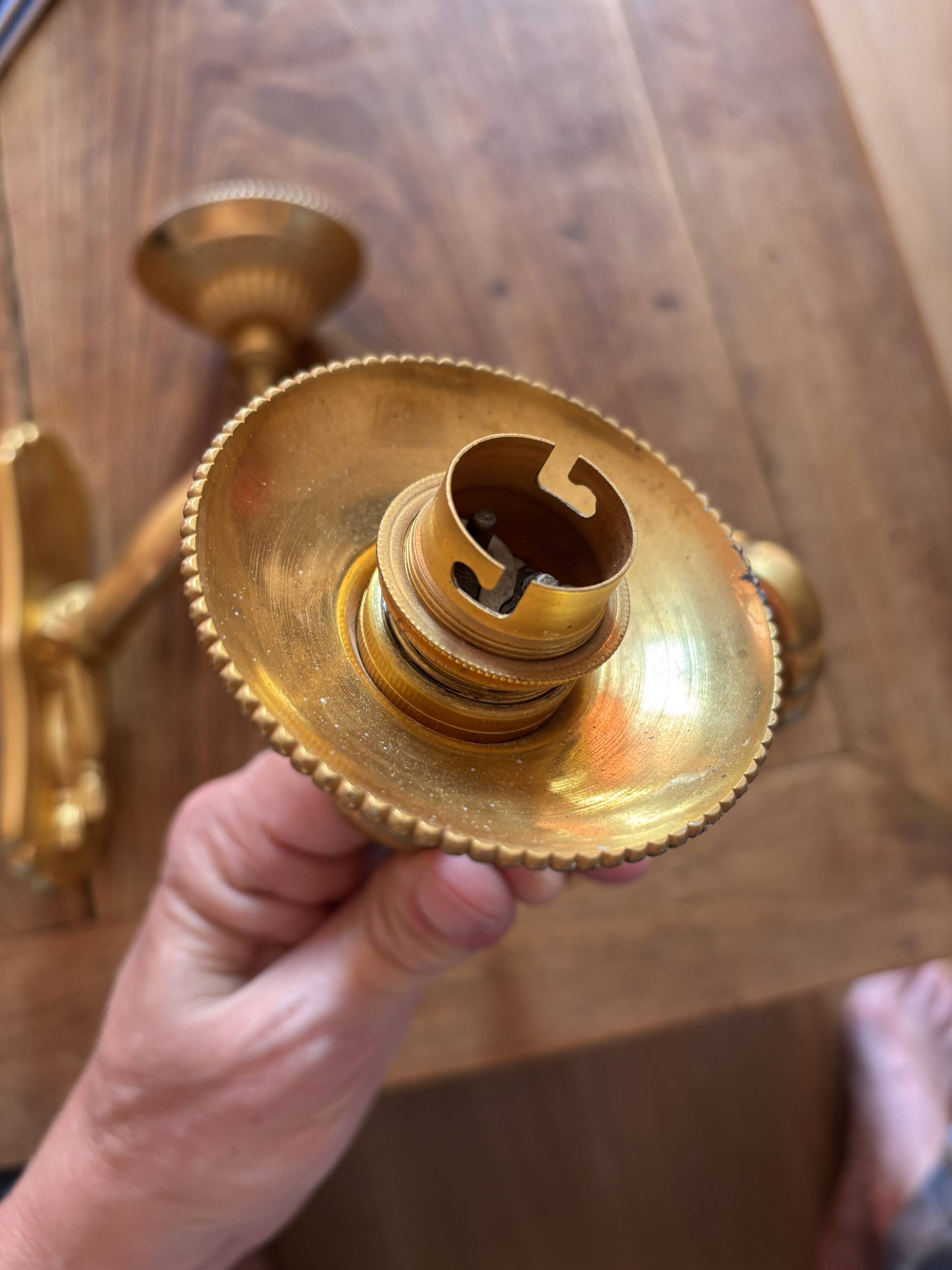 Pair of bronze wall sconces with outstretched arms and hands