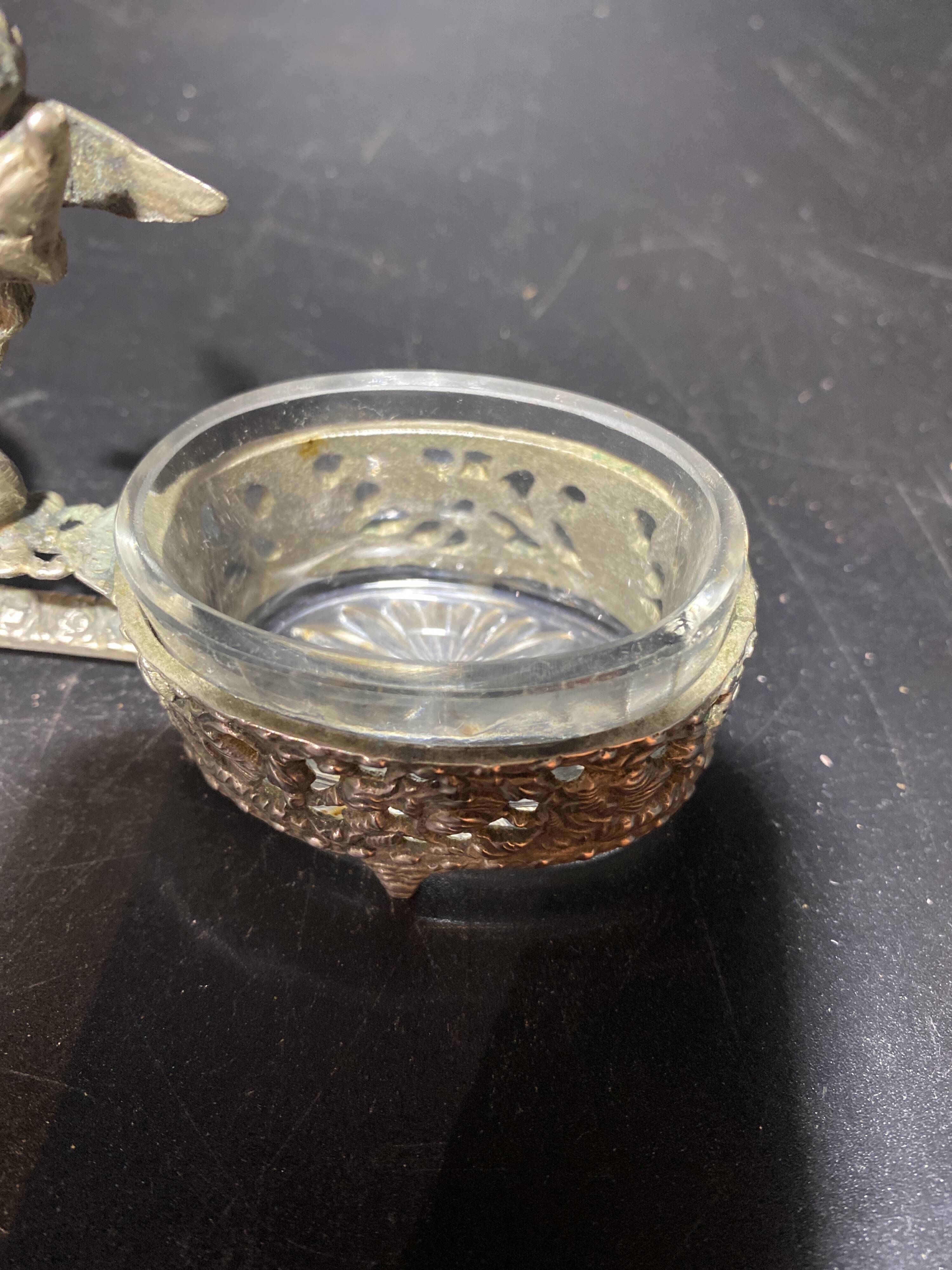 Spice centerpiece and serving spoon topped with a brass cherub