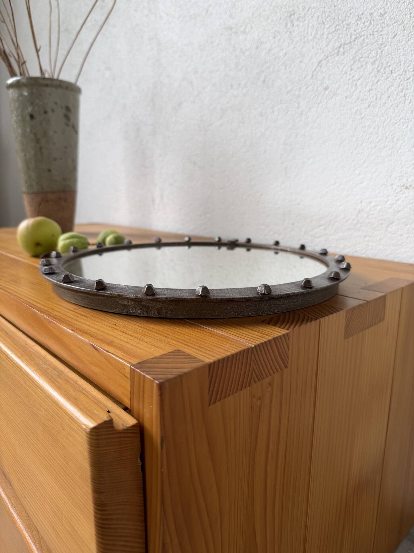 Brutalist round mirror with wrought iron and studs.