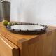 Brutalist round mirror with wrought iron and studs.