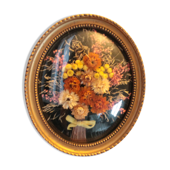 Golden vintage frame with bouquet of dried flowers under globe, wedding bouquet,