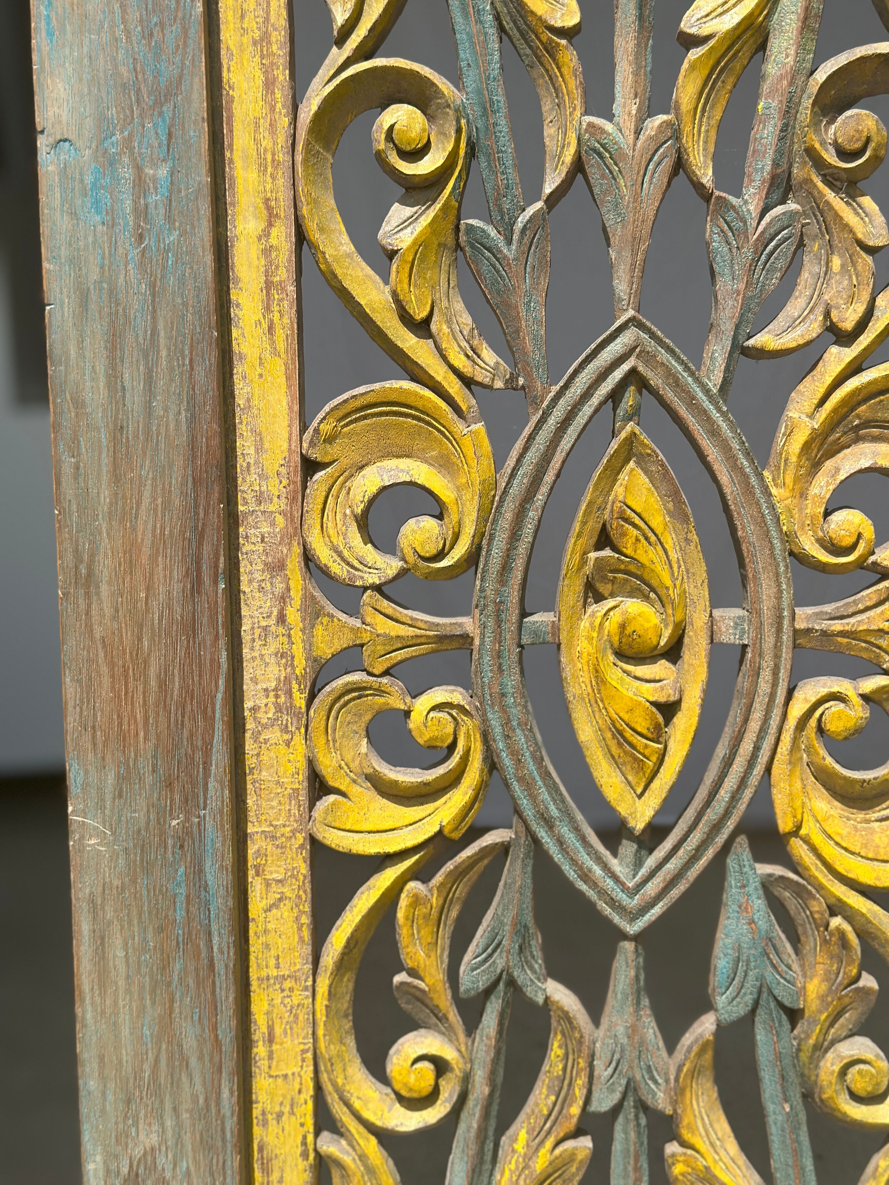 Rectangular Indonesian construction element with blue and yellow plant in carved wood