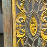 Rectangular Indonesian construction element with blue and yellow plant in carved wood