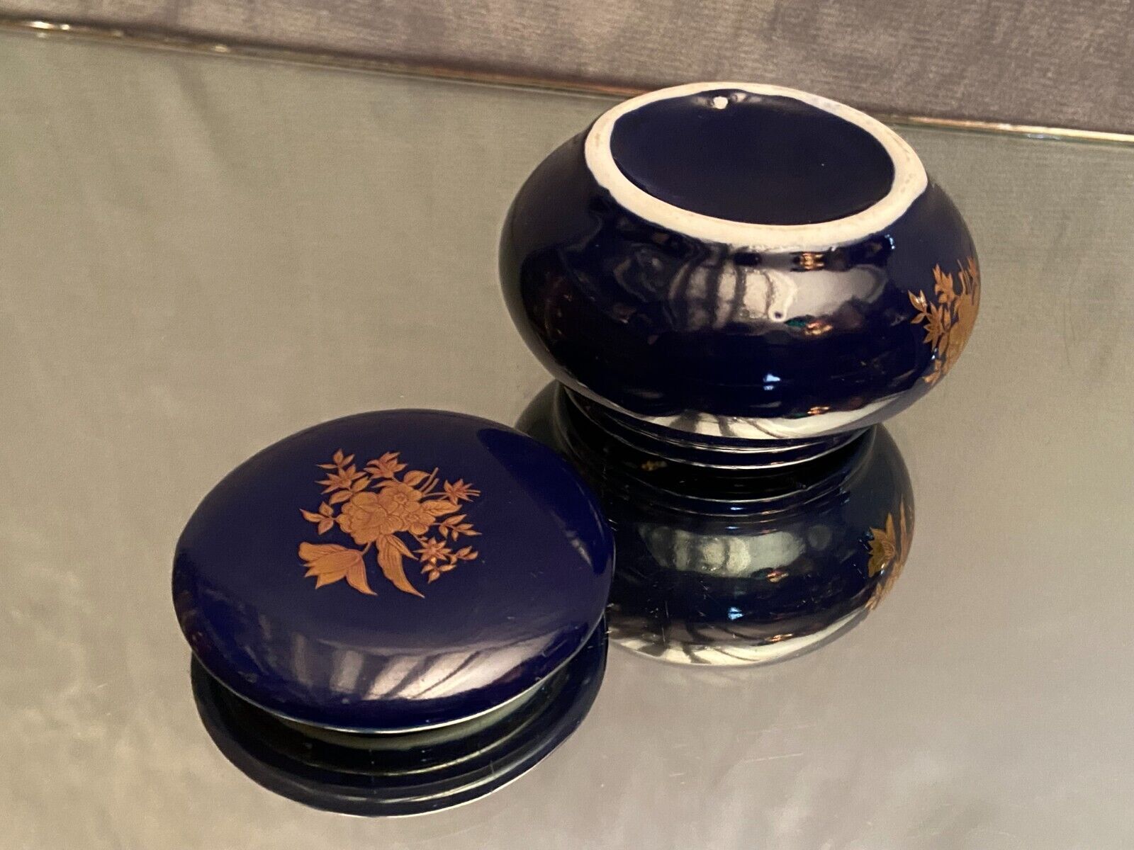 Porcelain candy box with golden floral decoration on a midnight blue background