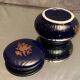 Porcelain candy box with golden floral decoration on a midnight blue background