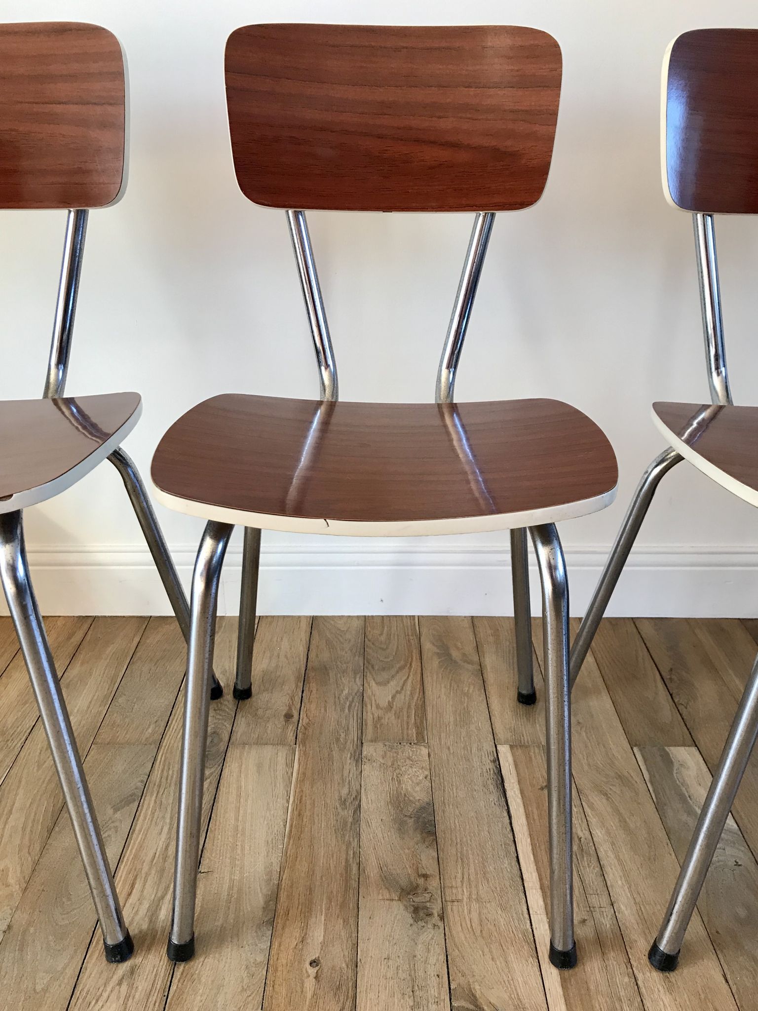 Trio of chairs in light brown formica and cream contour 70s