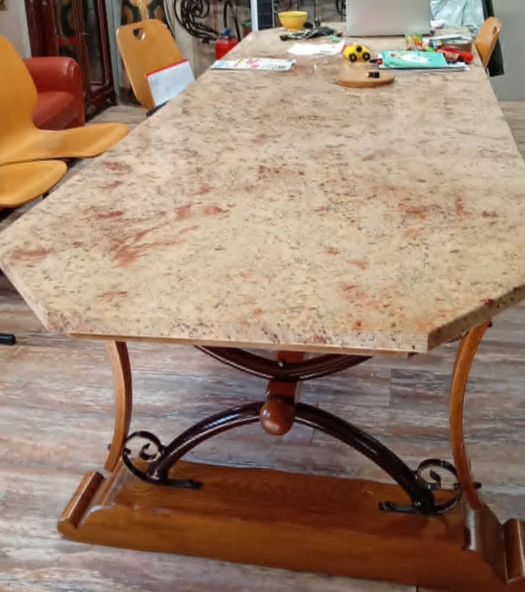 Large polished granite dining table on an oak and iron base.