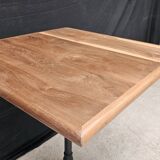 Bistro table with cast iron base and teak top