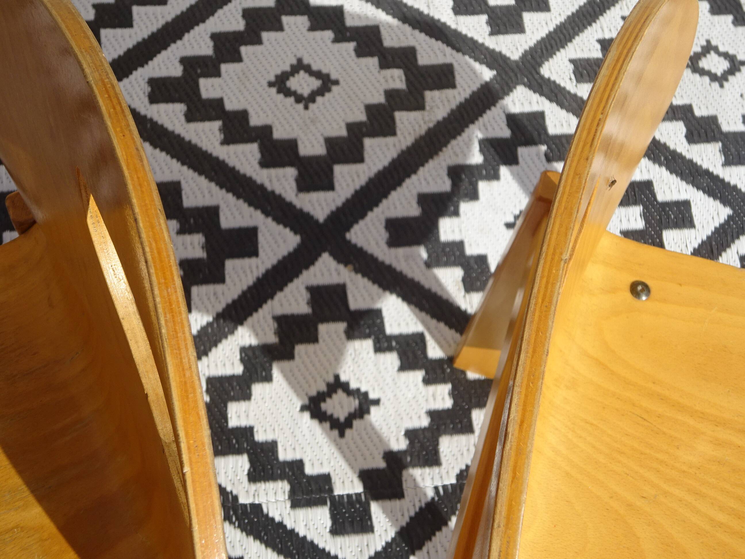 Pair of light wood chairs with post-formed seat and backrest.