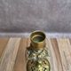 Antique brass candlestick with patina, openwork vintage foliage decoration.