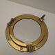 Mirror integrated into a brass navy porthole
