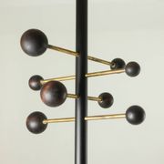 Coat rack from floor to ceiling in lacquered metal and brass. Contemporary.