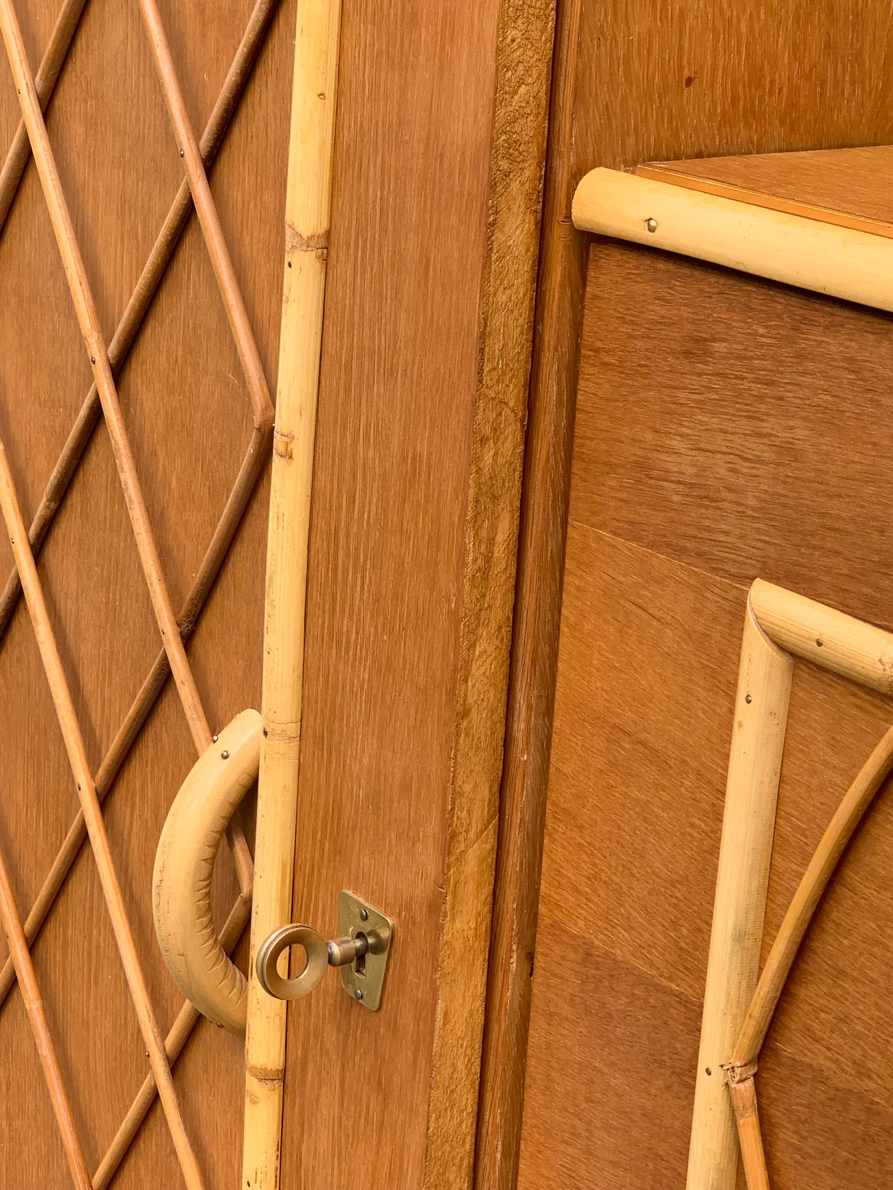 Rattan wardrobe with tapered legs from the 1960s.
