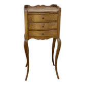 Small bedside table with a curved front and three drawers.