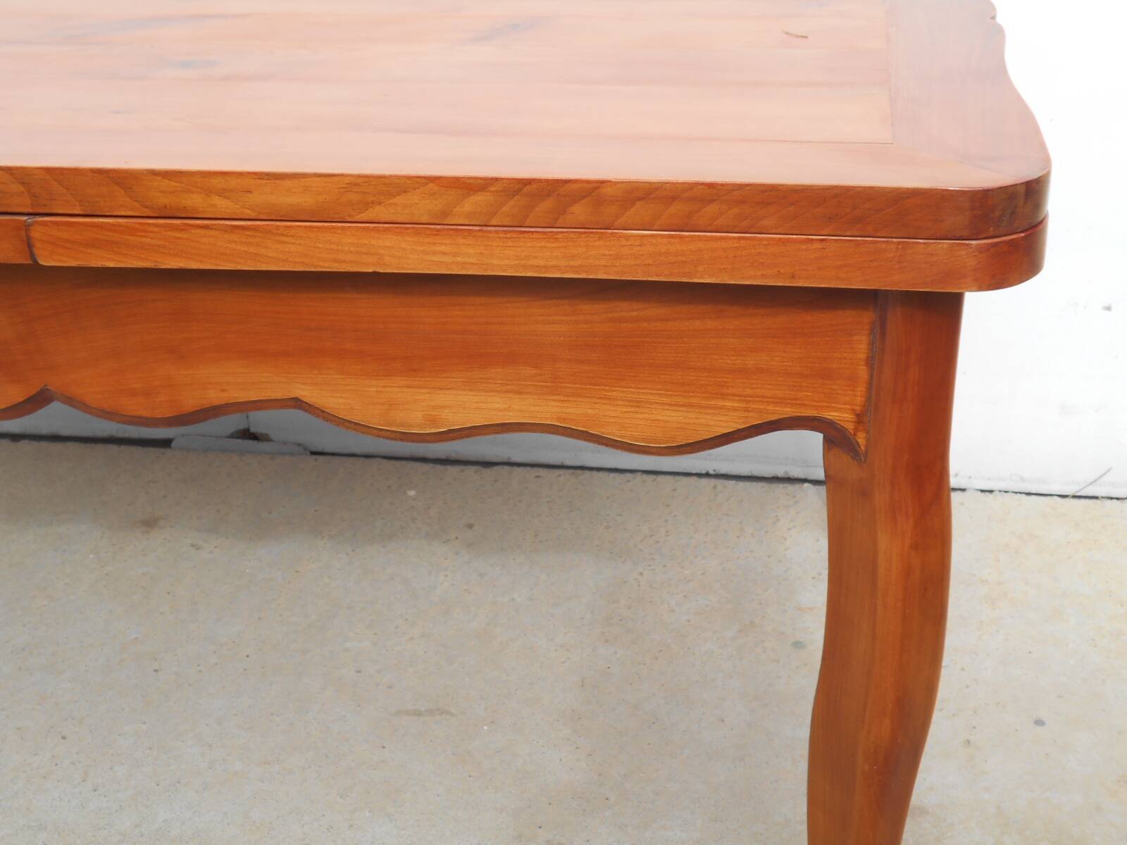 Large solid wood table with integrated extensions.