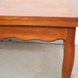 Large solid wood table with integrated extensions.