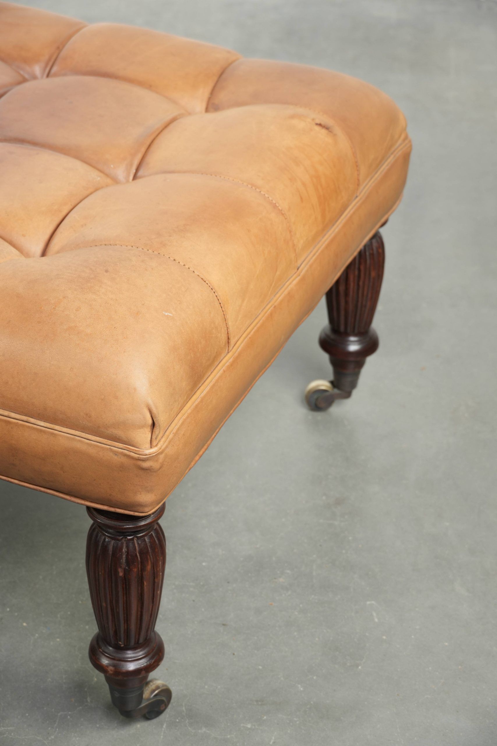 Sheepskin ottoman/coffee table on wheels in English chesterfield style