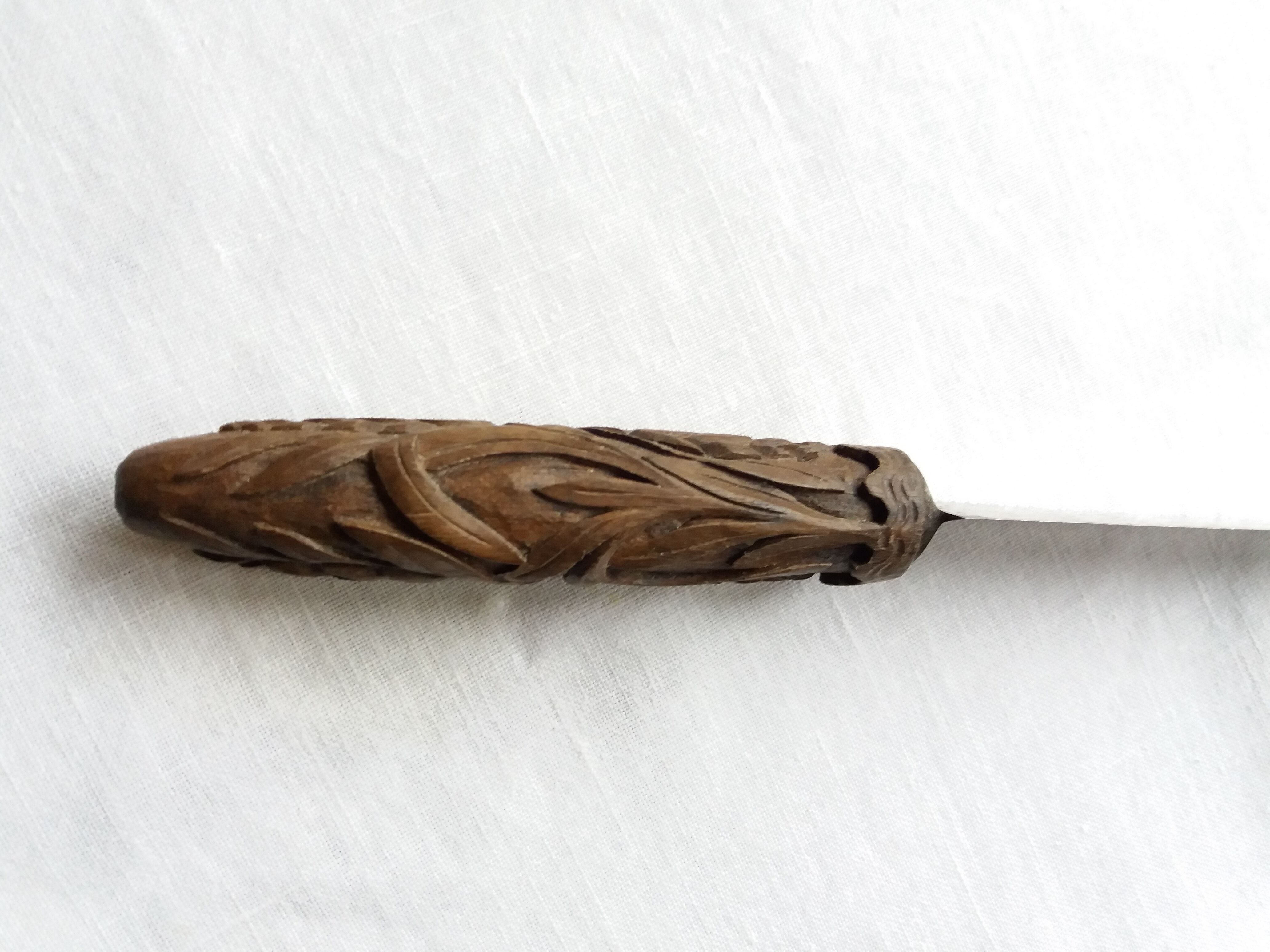 Old bread knife with a carved wooden handle