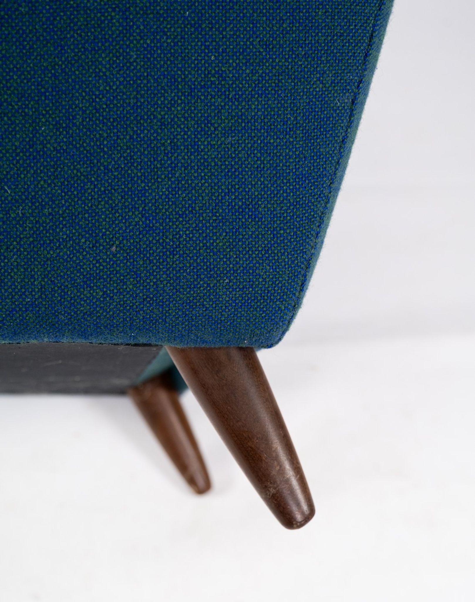 Armchair upholstered with dark blue wool fabric and legs in dark wood, of danish design, 1960s