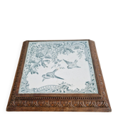 Antique musical trivet made of carved wood and Belle Époque earthenware.
