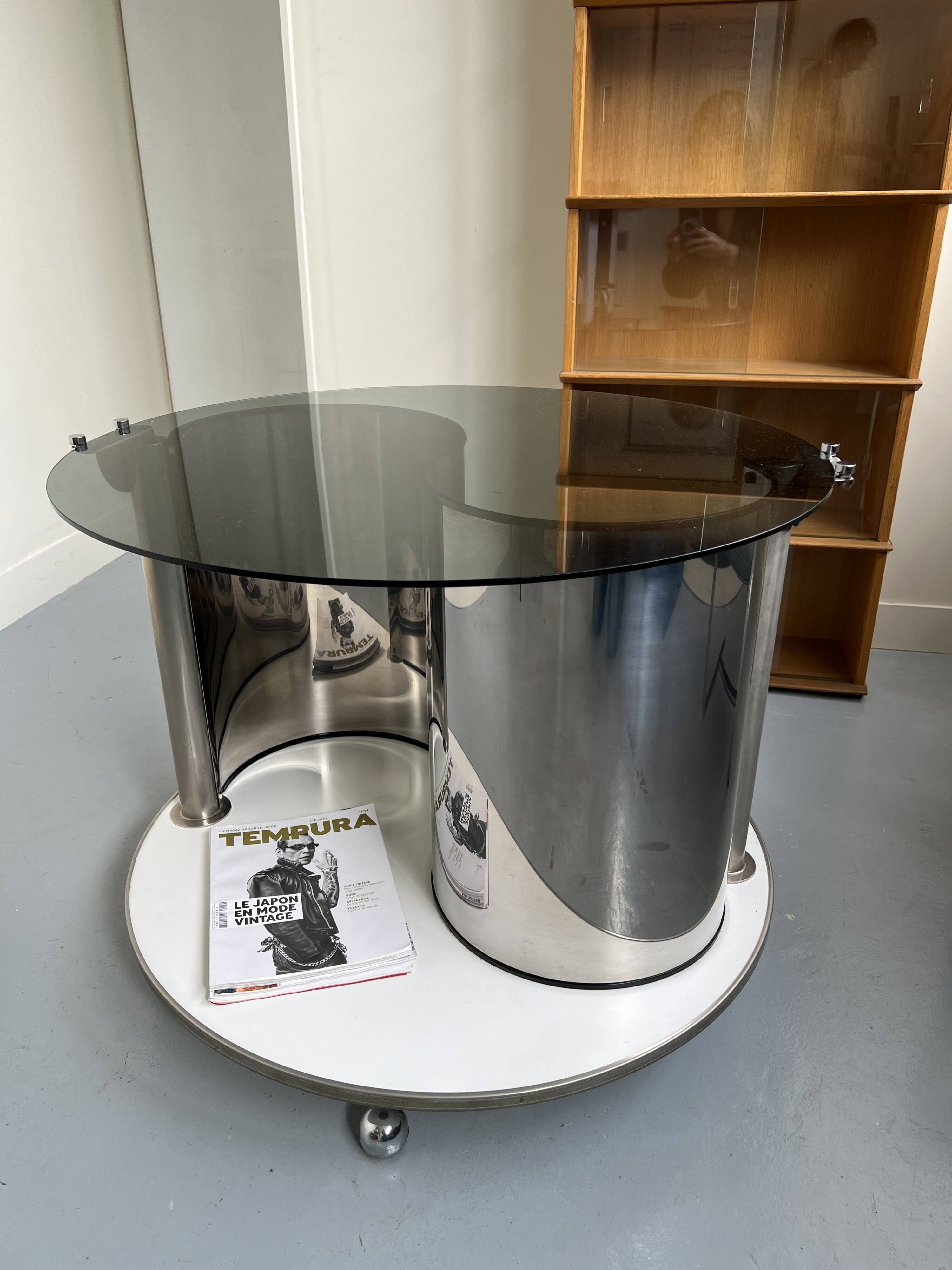 Vintage metal and smoked glass coffee table on casters bar