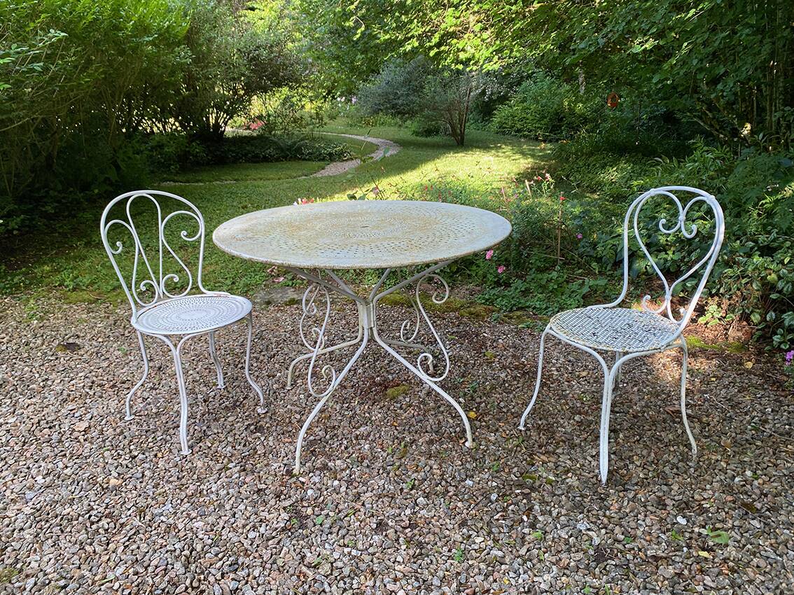 Part of a white lacquered wrought iron garden furniture set