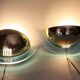 Pair of gold metal and plexiglass wall lights, circa 1980.