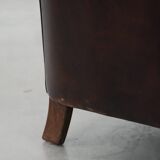 Stylish and sturdy dark brown club armchair made of sheepskin leather