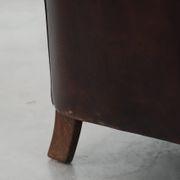 Stylish and sturdy dark brown club armchair made of sheepskin leather