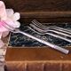 Five silver-plated metal appetizer forks with bamboo-style handles