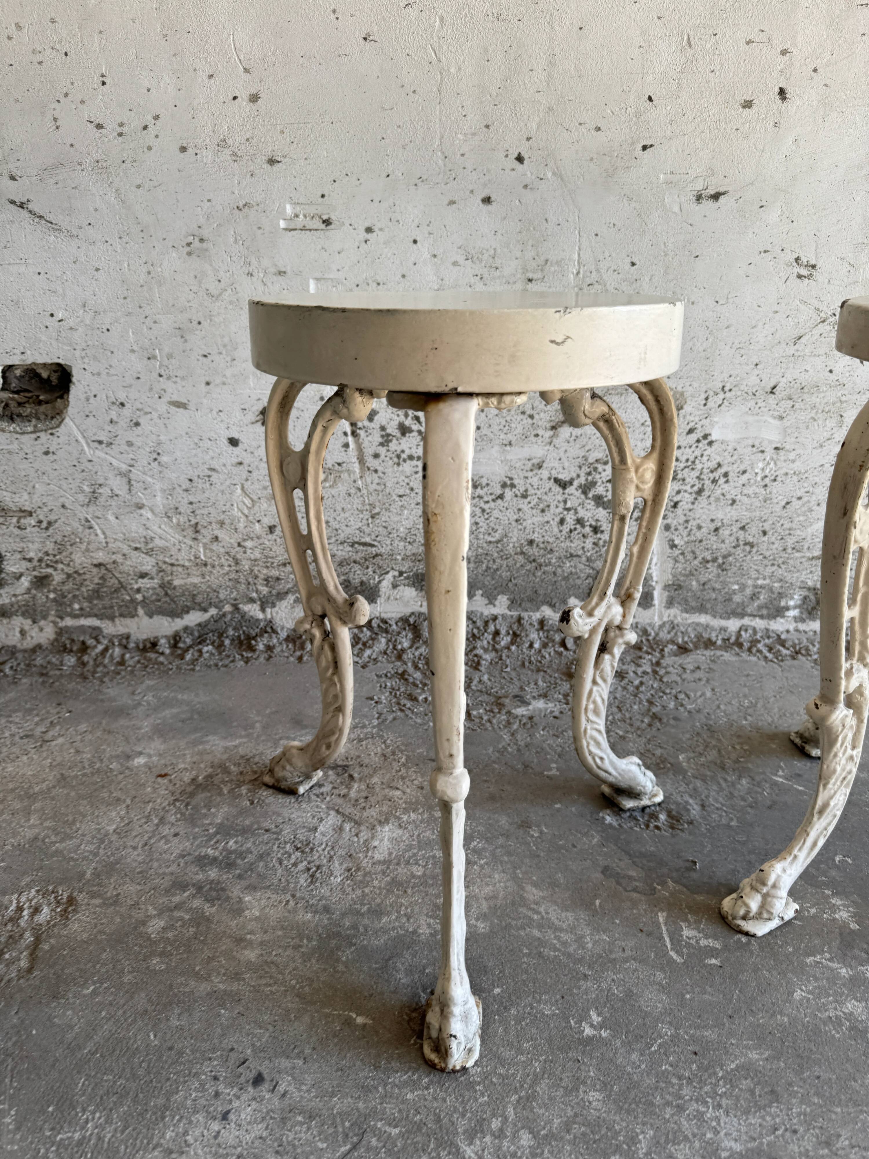 Pair of cream-white cast iron side tables with wooden tops — neoclassical shabby-chic