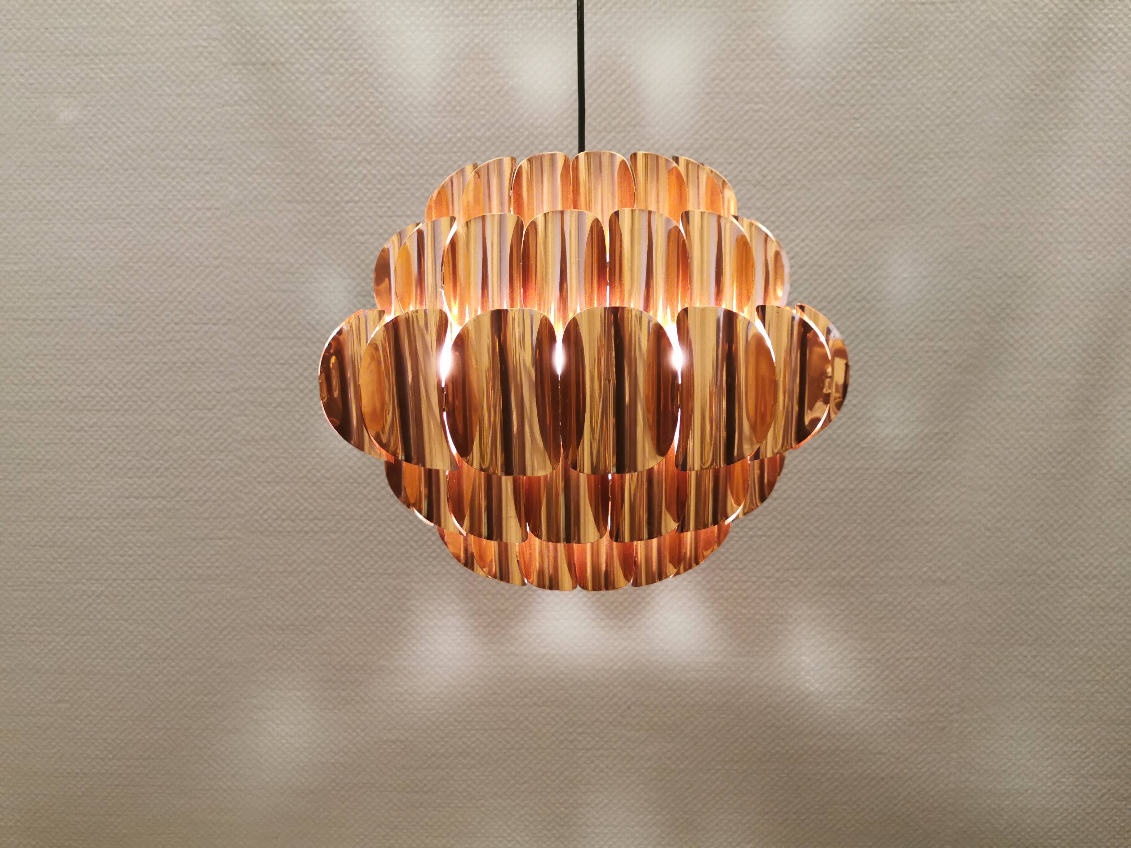 Copper colored hanging lamp. designed by thorsten orrling sweden