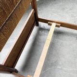 Brutalist style bed with chain and straw