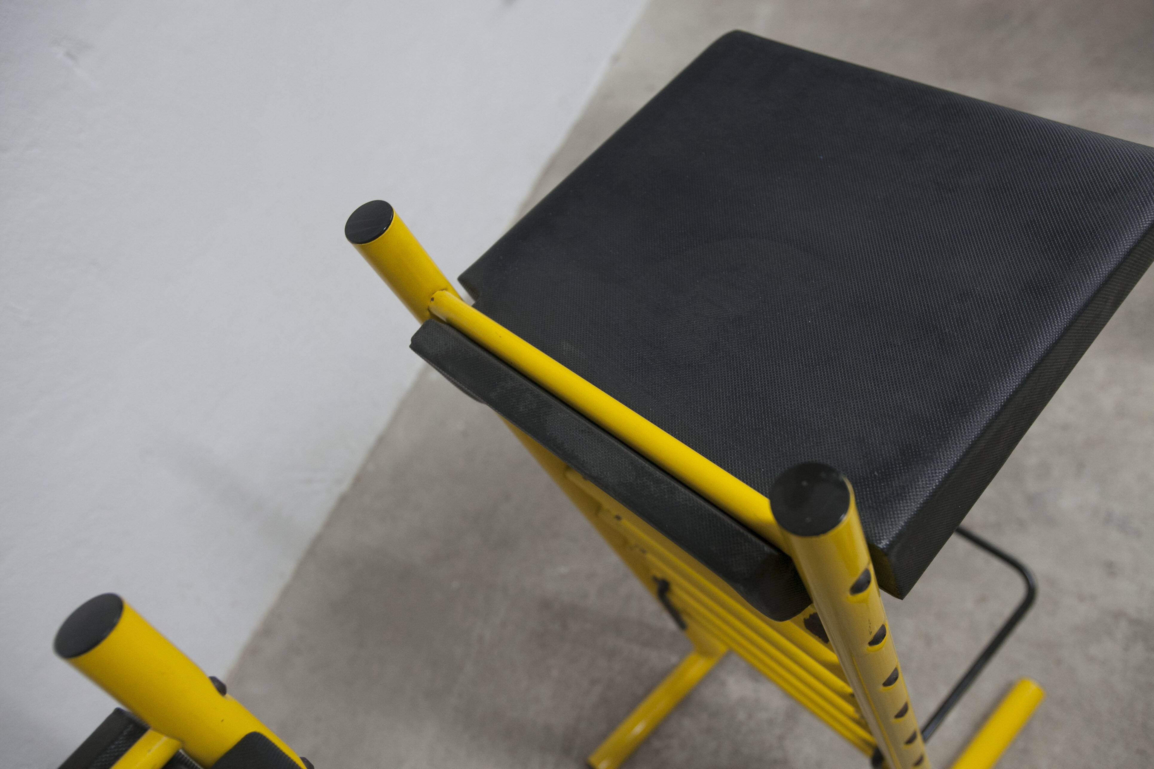 Pair of adjustable Italian bar stools in lacquered yellow and black