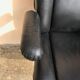 Vintage swivel black leather armchair