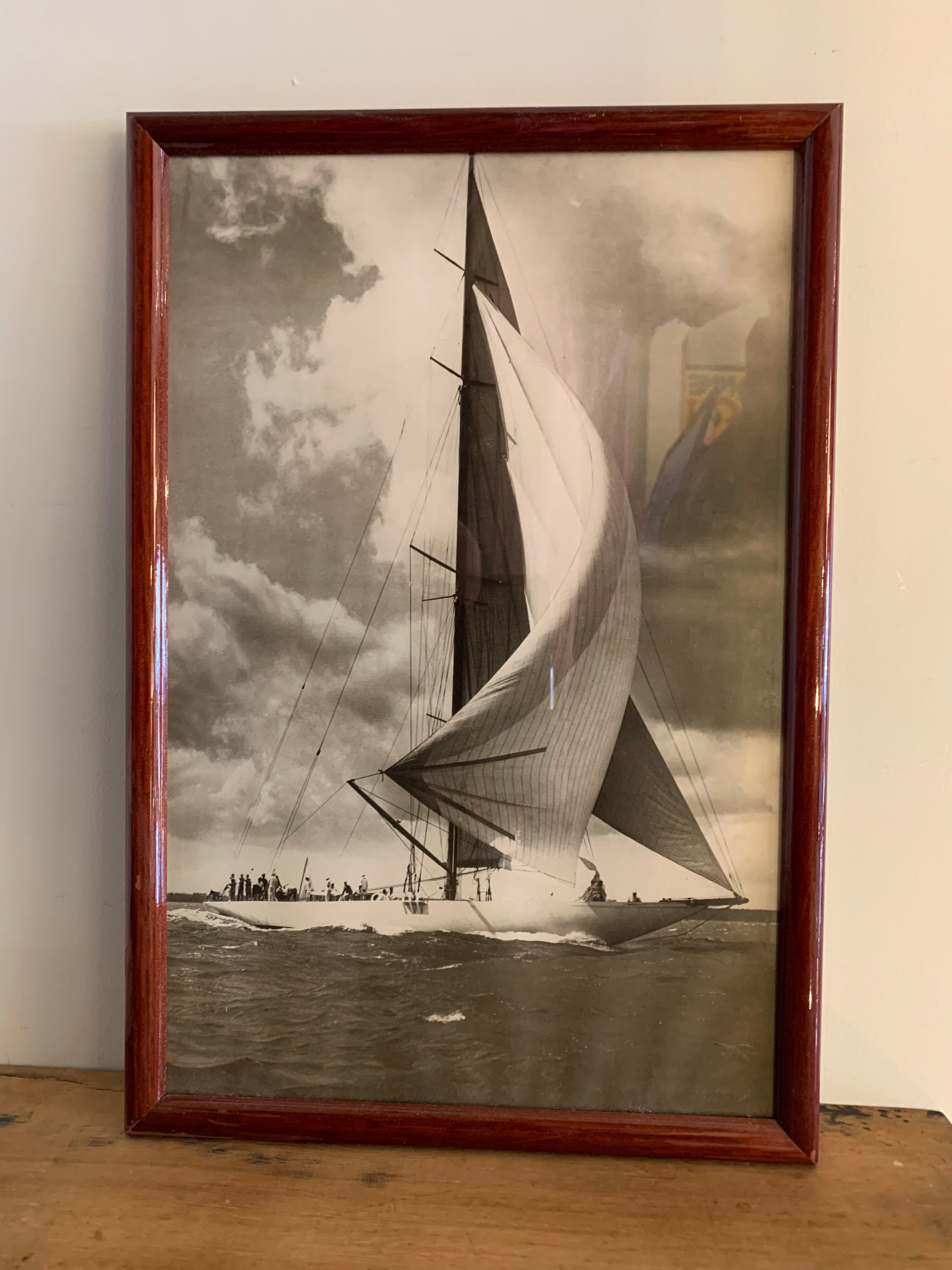 Three black and white-themed photographs sailboat boat with mahogany frame