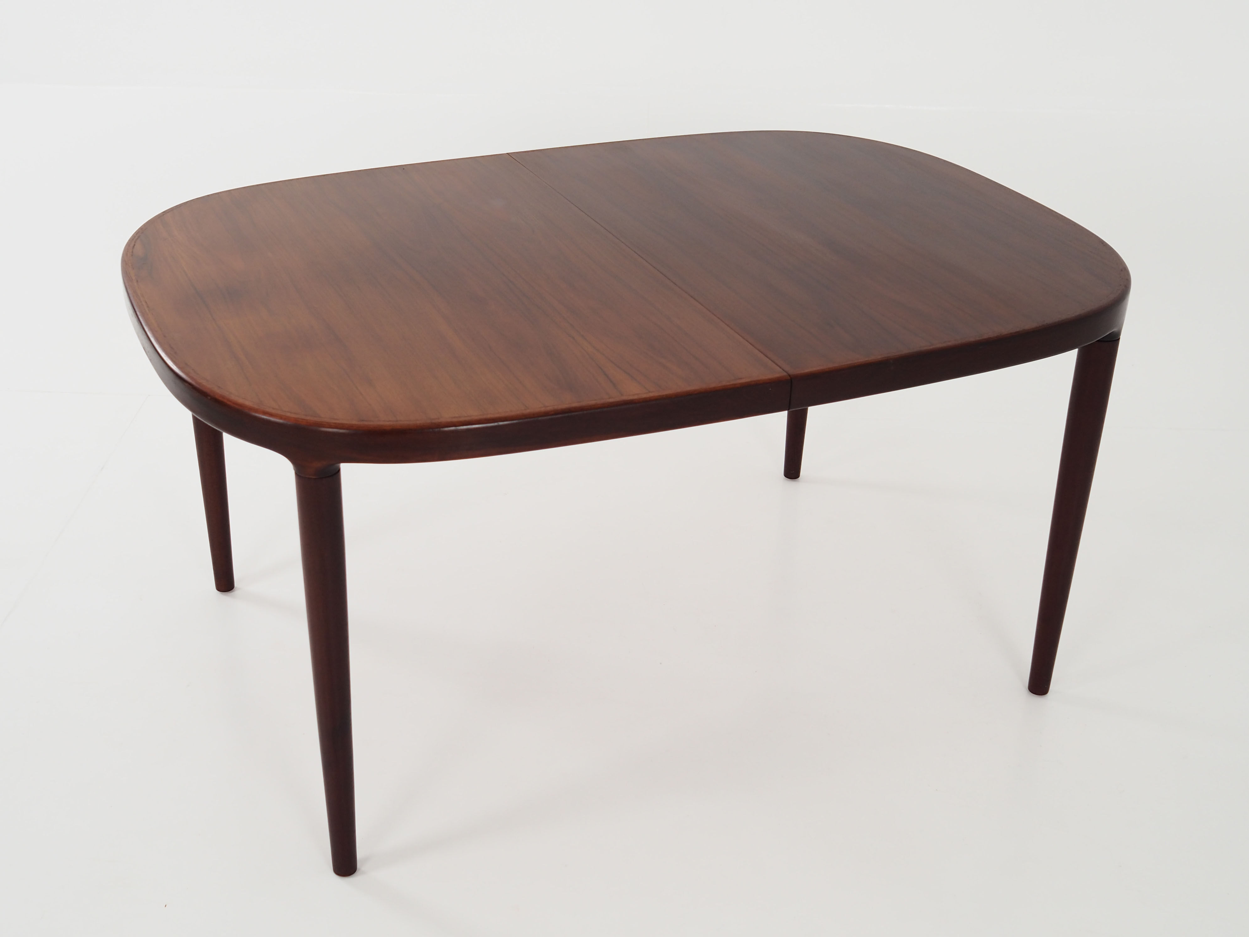 Oval table, covered with rosewood veneer.Design of the 70s