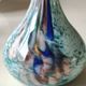 Ball vase soliflore with a long chimney neck. In speckled glass in the Murano style.