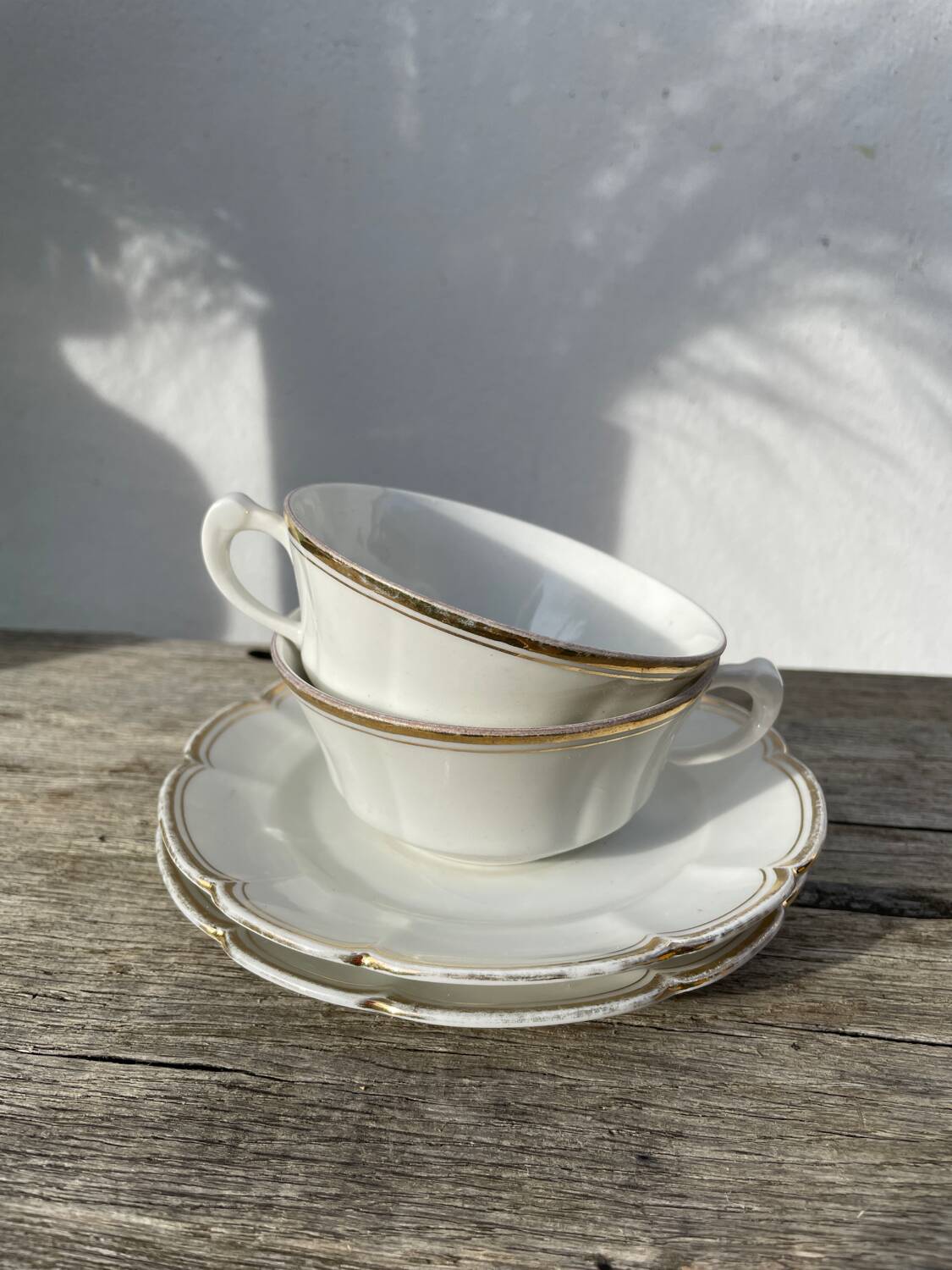 Pair of fine white and gold Limoges porcelain teacups