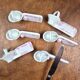 Set of 6 vintage porcelain knife rests with name markers, basket shape.