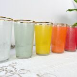 6 colorful juice glasses in their vintage basket