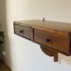 Small vintage wall console in patinated wood with two drawers.