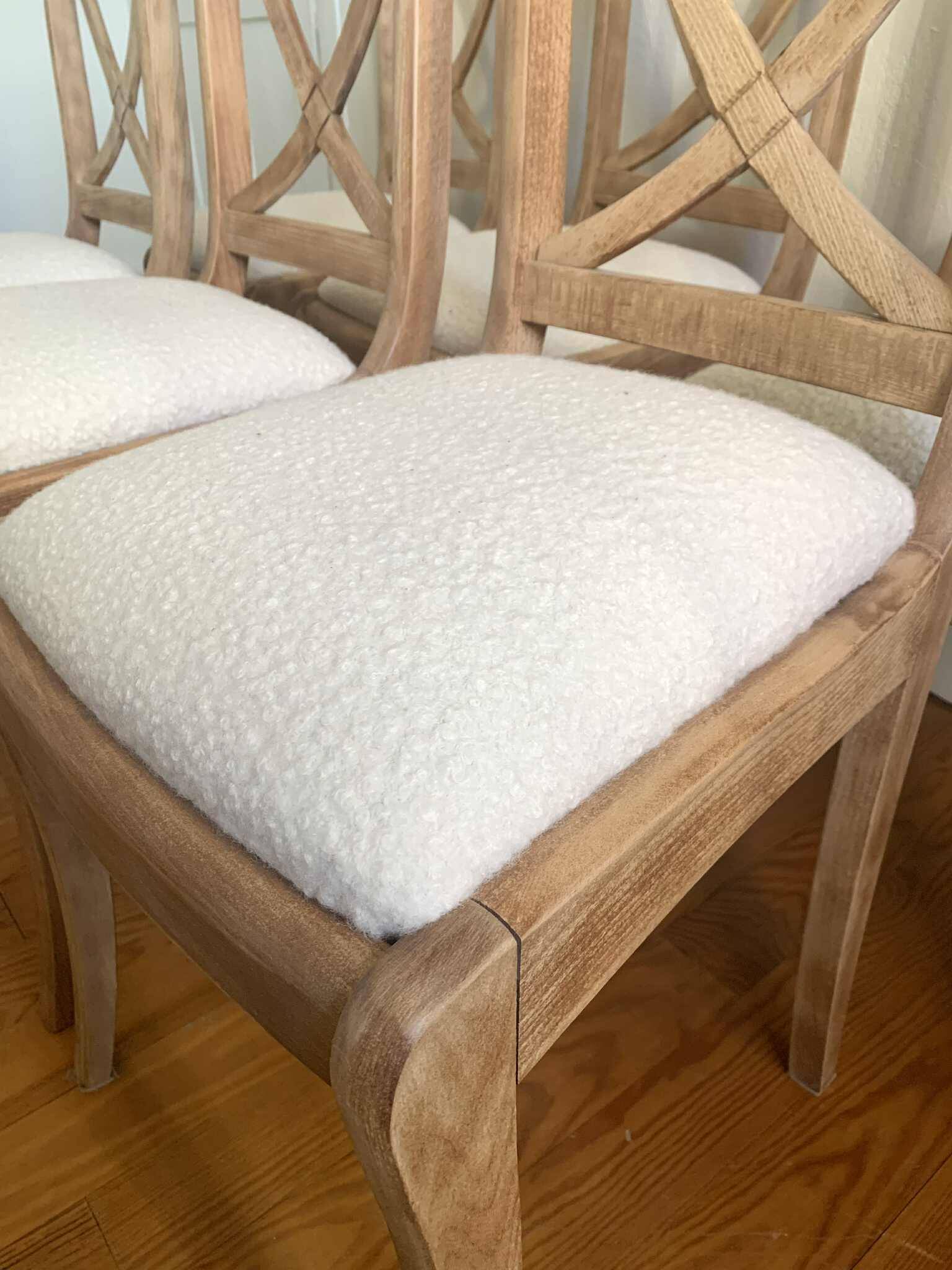 Set of 6 cross-back chairs in solid wood, with white boucle seats.